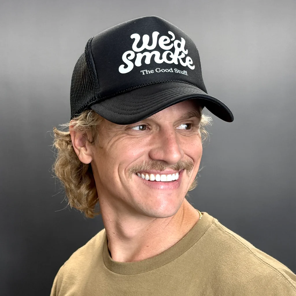 We'd Smoke Trucker Cap in black on a male model