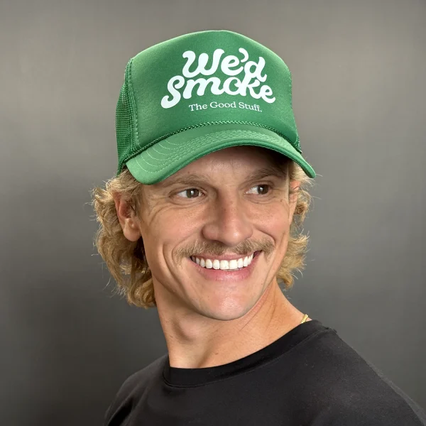 We'd Smoke Trucker Cap in green on a male model
